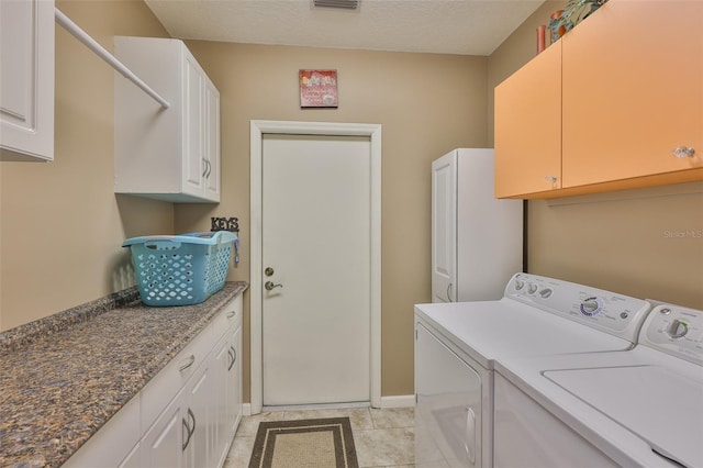 1111 Golfview Woods Dr Unit 1111, Sun City Center, FL 33573 - laundry area featuring separate washer and dryer, cabinet space, light tile patterned floors, and baseboards