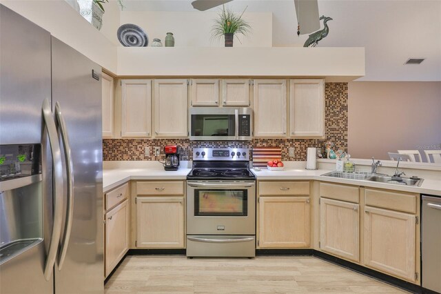 1111 Golfview Woods Dr Unit 1111, Sun City Center, FL 33573 - kitchen featuring stainless steel appliances, light brown cabinetry, a sink, and light countertops
