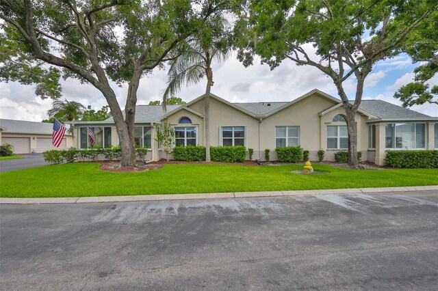 1111 Golfview Woods Dr Unit 1111, Sun City Center, FL 33573 - single story home featuring stucco siding and a front yard