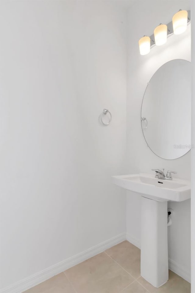 34234 Polacca Ln, Wesley Chapel, FL 33543 - bathroom featuring tile patterned flooring and baseboards