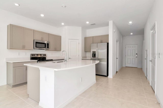 34234 Polacca Ln, Wesley Chapel, FL 33543 - kitchen featuring stainless steel appliances, a center island with sink, gray cabinets, recessed lighting, and light countertops