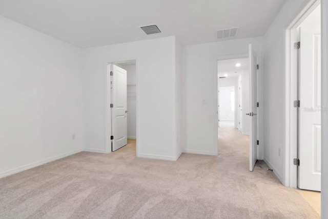34234 Polacca Ln, Wesley Chapel, FL 33543 - unfurnished bedroom with light colored carpet and a walk in closet
