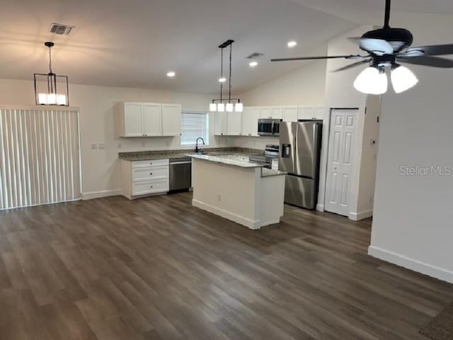 5635 NW 61st Ct, Ocala, FL 34482 - kitchen featuring appliances with stainless steel finishes, baseboards, a ceiling fan, a center island, and white cabinetry