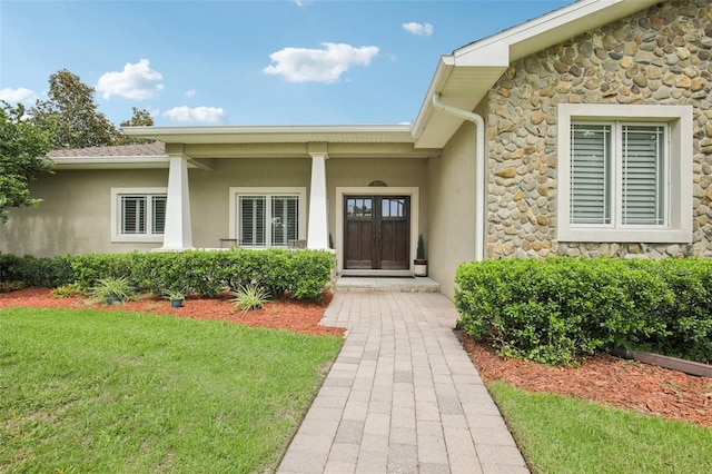 1803 143rd Ct E, Bradenton, FL 34212 - property entrance featuring stone siding, stucco siding, and a lawn