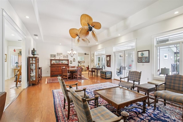 1803 143rd Ct E, Bradenton, FL 34212 - living room featuring healthy amount of natural light, a chandelier, a raised ceiling, light wood-style floors, and recessed lighting