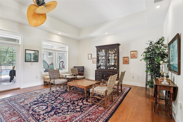 1803 143rd Ct E, Bradenton, FL 34212 - living room featuring wood finished floors, a tray ceiling, recessed lighting, and baseboards