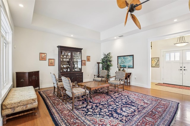 1803 143rd Ct E, Bradenton, FL 34212 - living area with wood finished floors, a raised ceiling, baseboards, recessed lighting, and a ceiling fan