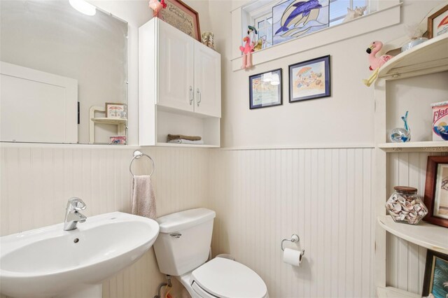 1803 143rd Ct E, Bradenton, FL 34212 - bathroom featuring a sink, wainscoting, and toilet
