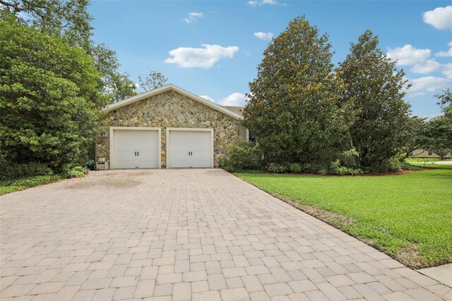 1803 143rd Ct E, Bradenton, FL 34212 - view of front facade with stone siding, decorative driveway, a front lawn, and an attached garage