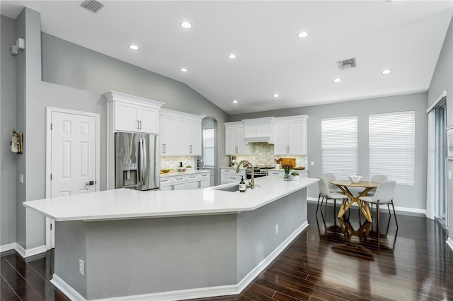 9608 Greenpointe Dr, Tampa, FL 33626 - kitchen featuring stainless steel refrigerator with ice dispenser, dark wood-type flooring, a spacious island, a sink, and vaulted ceiling