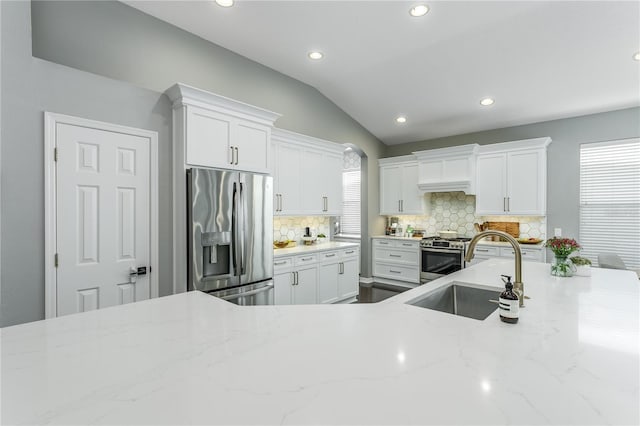 9608 Greenpointe Dr, Tampa, FL 33626 - kitchen featuring appliances with stainless steel finishes, recessed lighting, white cabinets, tasteful backsplash, and lofted ceiling