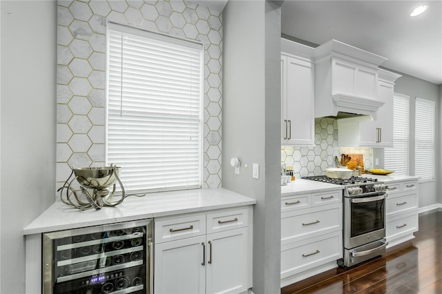 9608 Greenpointe Dr, Tampa, FL 33626 - kitchen featuring gas range, beverage cooler, dark wood-style floors, white cabinetry, and backsplash