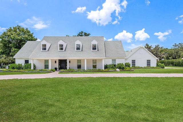 2395 Campbell Rd, Clearwater, FL 33765 - cape cod home featuring a front lawn and a shingled roof