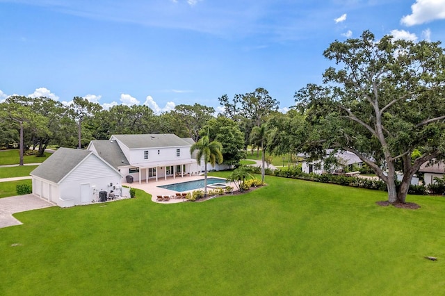 2395 Campbell Rd, Clearwater, FL 33765 - back of house with a lawn, an outdoor pool, and a garage