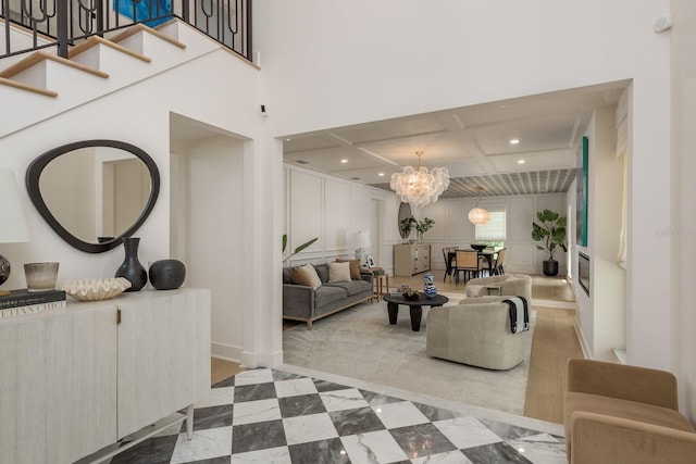 2395 Campbell Rd, Clearwater, FL 33765 - living room with coffered ceiling, a chandelier, recessed lighting, stairway, and beamed ceiling