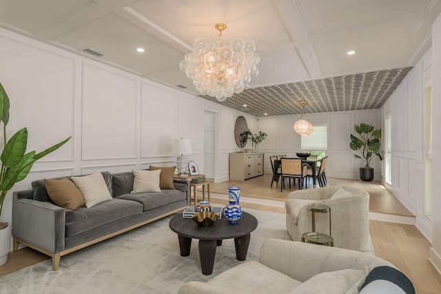 2395 Campbell Rd, Clearwater, FL 33765 - living area featuring a decorative wall, light wood-style floors, a chandelier, coffered ceiling, and recessed lighting