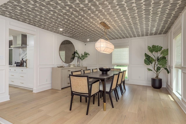 2395 Campbell Rd, Clearwater, FL 33765 - dining space with a decorative wall, light wood finished floors, and healthy amount of natural light