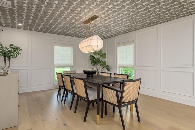 2395 Campbell Rd, Clearwater, FL 33765 - dining area with a decorative wall and light wood-type flooring