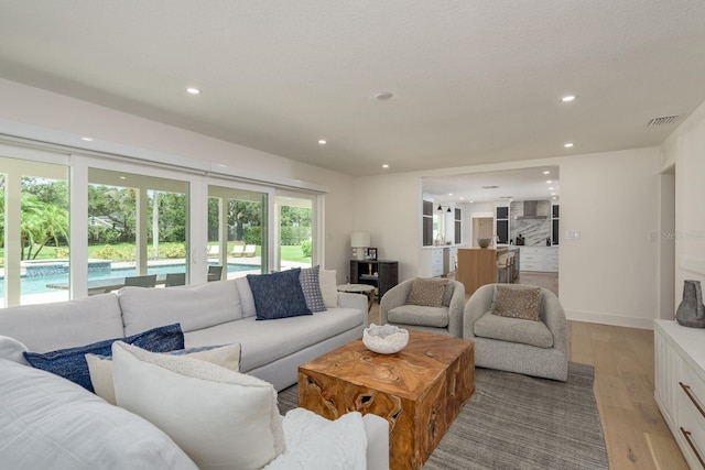 2395 Campbell Rd, Clearwater, FL 33765 - living area featuring light wood-type flooring and recessed lighting