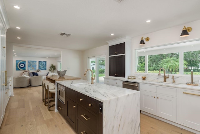 2395 Campbell Rd, Clearwater, FL 33765 - kitchen with a sink, dishwasher, white cabinetry, open floor plan, and recessed lighting