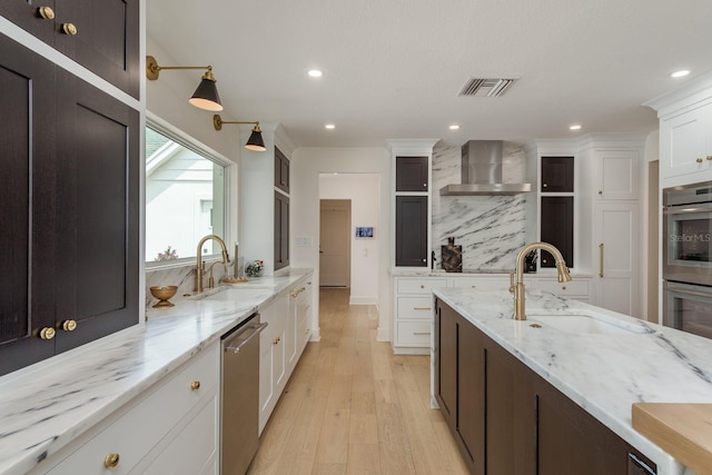 2395 Campbell Rd, Clearwater, FL 33765 - kitchen with stainless steel appliances, a sink, wall chimney exhaust hood, white cabinetry, and recessed lighting