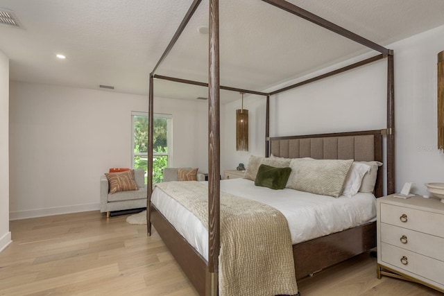 2395 Campbell Rd, Clearwater, FL 33765 - bedroom featuring light wood-style flooring, baseboards, recessed lighting, and a textured ceiling