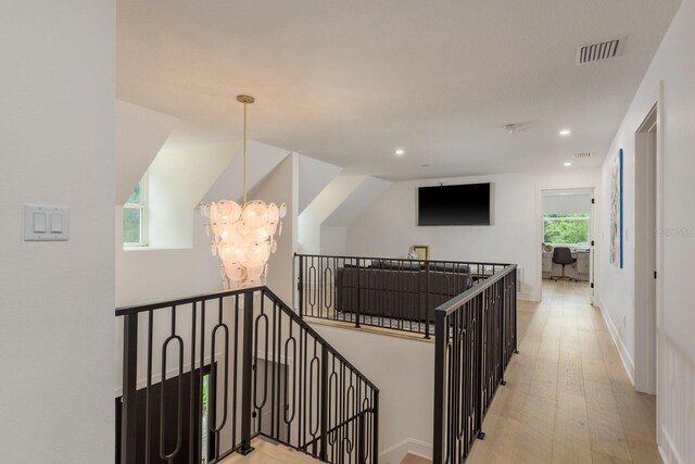 2395 Campbell Rd, Clearwater, FL 33765 - hall with a chandelier, an upstairs landing, recessed lighting, wood finished floors, and baseboards