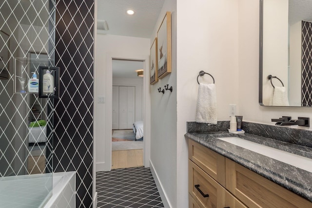 2395 Campbell Rd, Clearwater, FL 33765 - full bath with vanity, a tile shower, baseboards, and tile patterned floors
