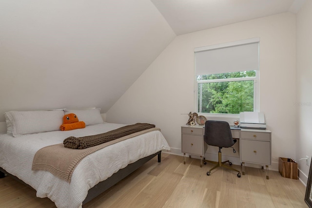 2395 Campbell Rd, Clearwater, FL 33765 - bedroom featuring light wood-style floors, vaulted ceiling, and baseboards