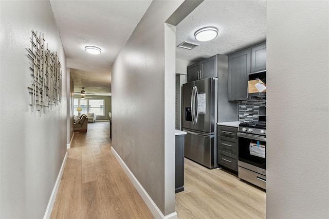 2960 59th St S Unit 303, Gulfport, FL 33707 - corridor featuring light wood-style flooring, baseboards, and a textured ceiling