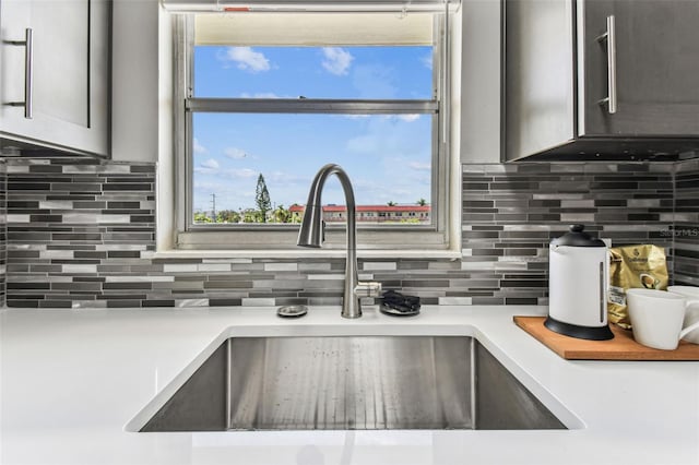 2960 59th St S Unit 303, Gulfport, FL 33707 - kitchen view of a sink, light countertops, and decorative backsplash