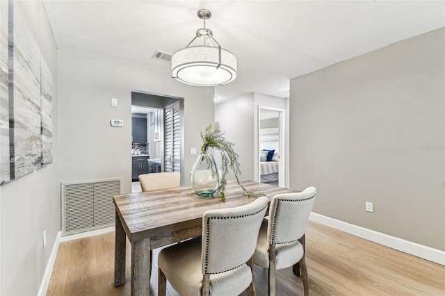 2960 59th St S Unit 303, Gulfport, FL 33707 - dining space with light wood-style floors and baseboards