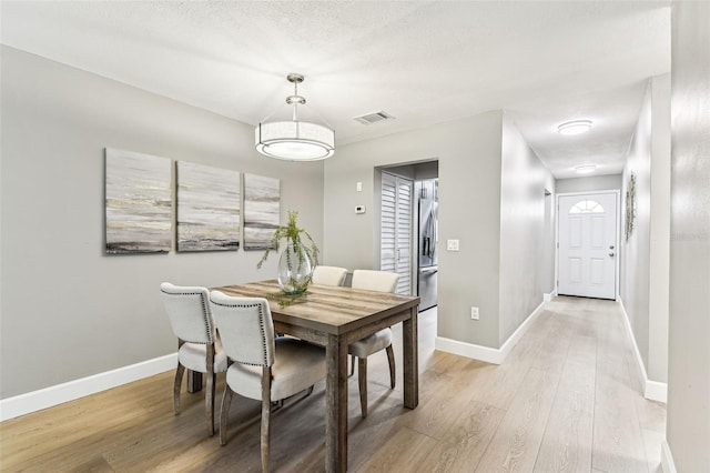 2960 59th St S Unit 303, Gulfport, FL 33707 - dining area featuring light wood-style floors and baseboards