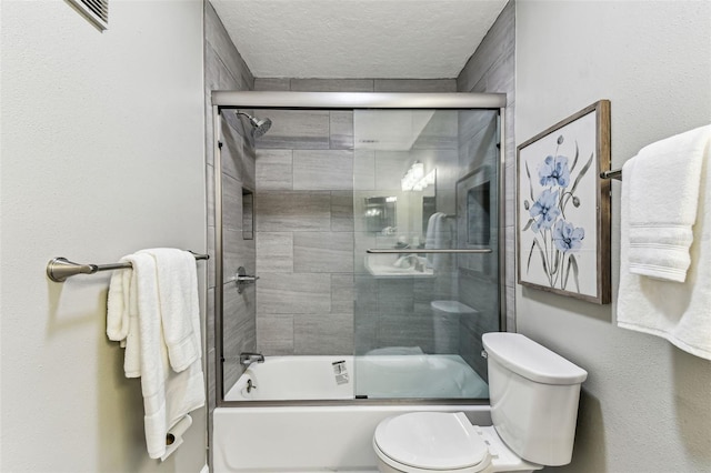 2960 59th St S Unit 303, Gulfport, FL 33707 - full bathroom with toilet, enclosed tub / shower combo, and a textured ceiling