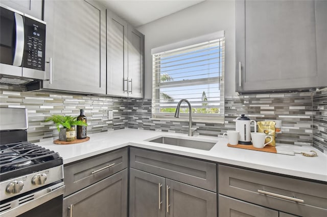2960 59th St S Unit 303, Gulfport, FL 33707 - kitchen featuring appliances with stainless steel finishes, gray cabinetry, and tasteful backsplash