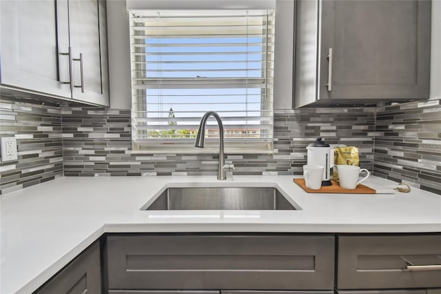 2960 59th St S Unit 303, Gulfport, FL 33707 - kitchen with gray cabinets, light countertops, and decorative backsplash