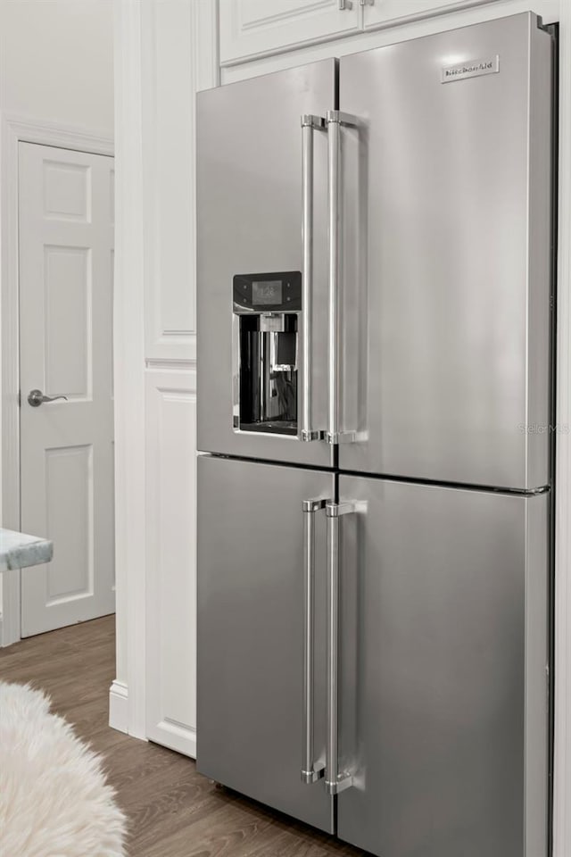 146 26th Ave NE, Saint Petersburg, FL 33704 - kitchen featuring high end fridge, wood finished floors, and white cabinetry