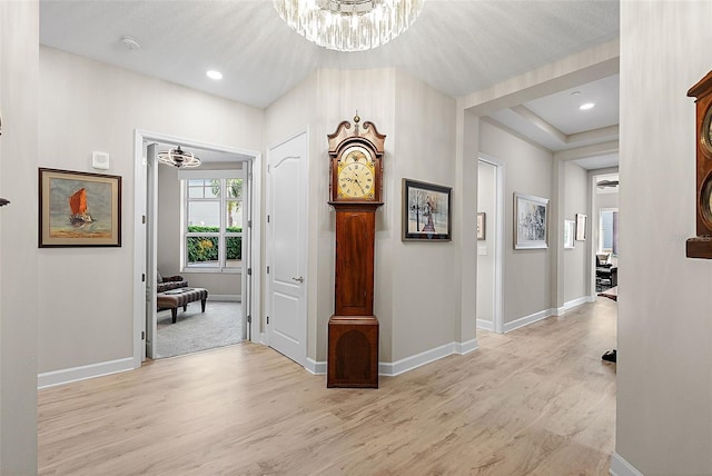 100 Beach Dr NE Unit 301, Saint Petersburg, FL 33701 - corridor featuring a chandelier, light wood-style flooring, baseboards, and recessed lighting