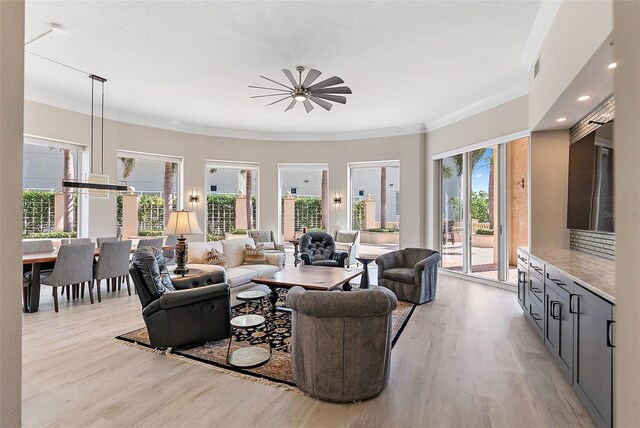 100 Beach Dr NE Unit 301, Saint Petersburg, FL 33701 - living area with light wood-style flooring, crown molding, and healthy amount of natural light