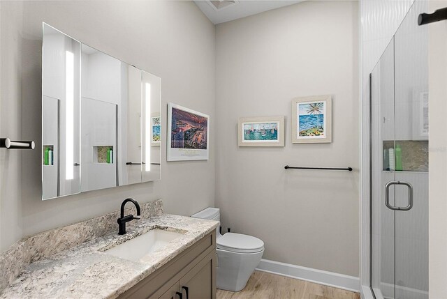 100 Beach Dr NE Unit 301, Saint Petersburg, FL 33701 - full bath featuring vanity, a shower stall, toilet, wood finished floors, and baseboards