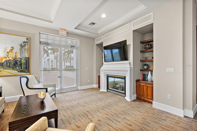 100 Beach Dr NE Unit 301, Saint Petersburg, FL 33701 - living area with a raised ceiling, ornamental molding, light carpet, a glass covered fireplace, and baseboards