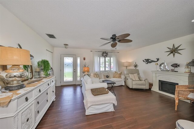 1224 W Del Webb Blvd, Sun City Center, FL 33573 - living area with dark wood finished floors, ceiling fan, a glass covered fireplace, and a textured ceiling