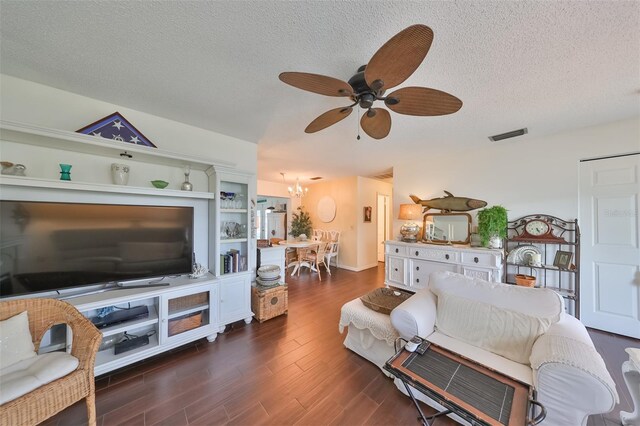 1224 W Del Webb Blvd, Sun City Center, FL 33573 - living area featuring a ceiling fan, a chandelier, a textured ceiling, and dark wood finished floors