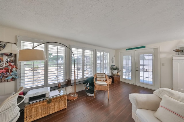 1224 W Del Webb Blvd, Sun City Center, FL 33573 - living room with a textured ceiling, wood finished floors, plenty of natural light, and french doors