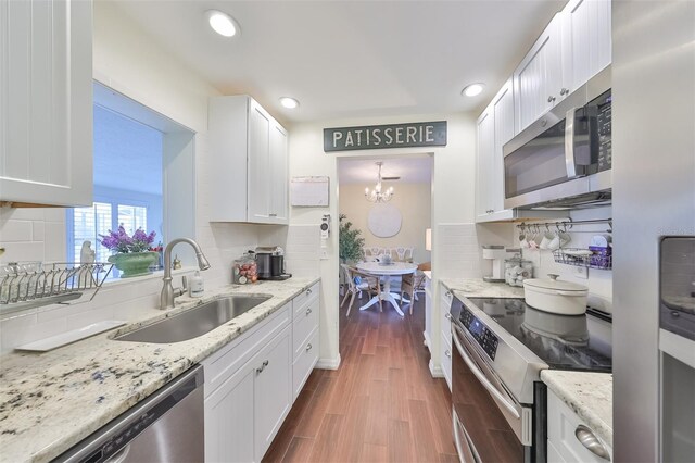 1224 W Del Webb Blvd, Sun City Center, FL 33573 - kitchen featuring stainless steel appliances, backsplash, white cabinets, dark wood-style floors, and recessed lighting