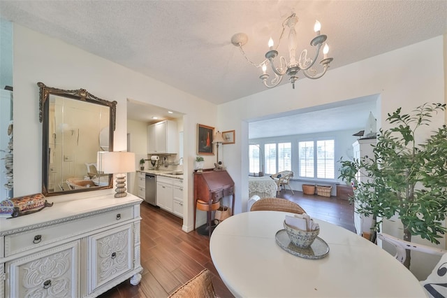 1224 W Del Webb Blvd, Sun City Center, FL 33573 - dining area featuring a chandelier, a textured ceiling, and dark wood-type flooring