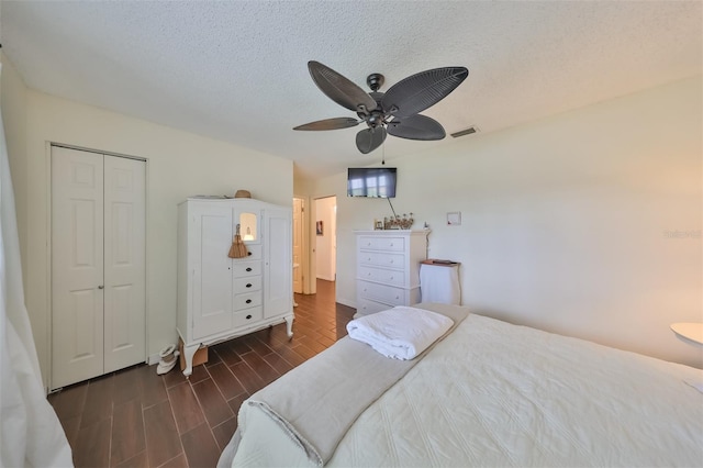 1224 W Del Webb Blvd, Sun City Center, FL 33573 - bedroom with a closet, a ceiling fan, a textured ceiling, and wood finish floors