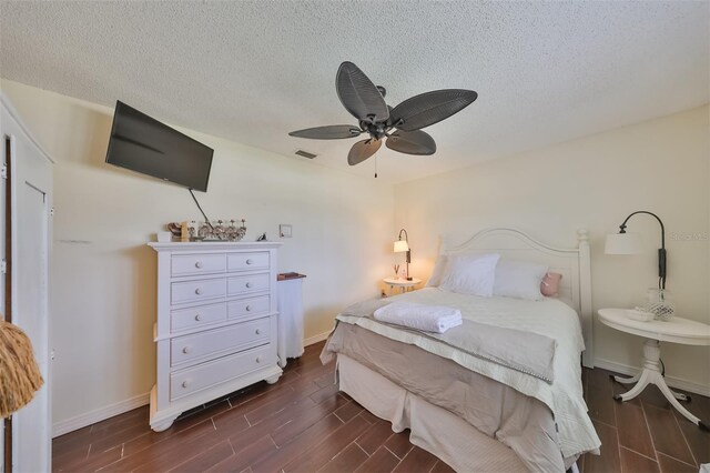 1224 W Del Webb Blvd, Sun City Center, FL 33573 - bedroom featuring dark wood finished floors, a textured ceiling, and ceiling fan