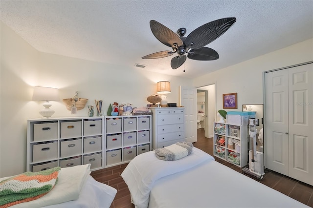 1224 W Del Webb Blvd, Sun City Center, FL 33573 - bedroom featuring wood tiled floors, a ceiling fan, a textured ceiling, and a closet