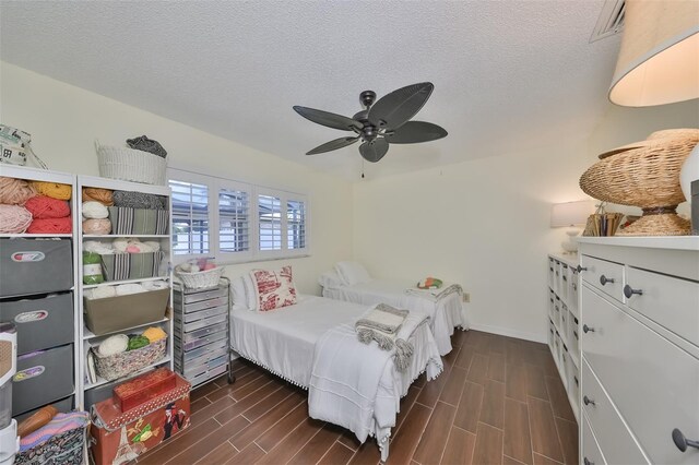 1224 W Del Webb Blvd, Sun City Center, FL 33573 - bedroom featuring dark wood-style floors, ceiling fan, and a textured ceiling